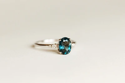 Ring with 8X6MM Oval London Blue Topaz and .04 Carat TW of Diamonds in 14kt White Gold