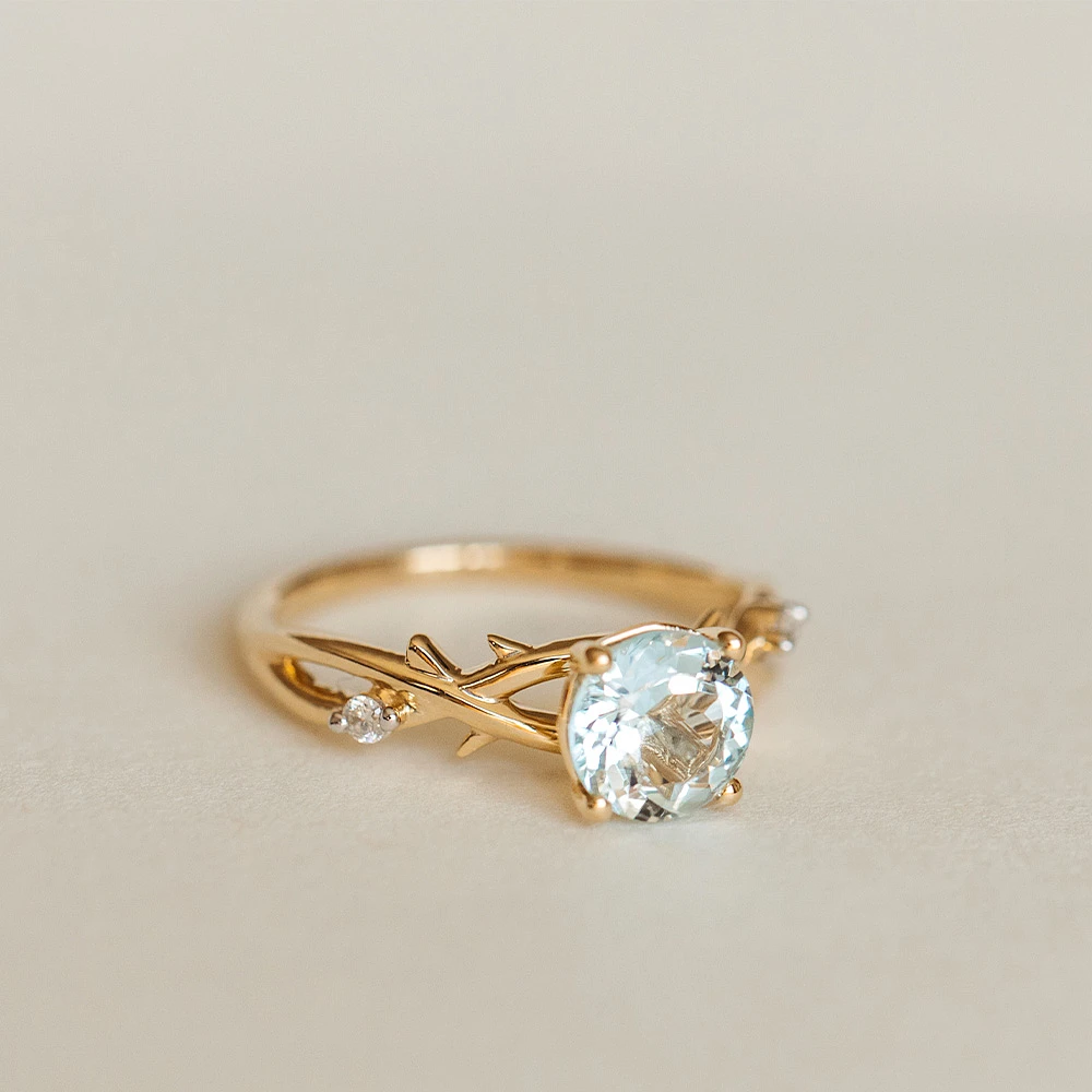 Ring with 7MM Round Aquamarine and .04 Carat TW of Diamonds 14kt Yellow Gold