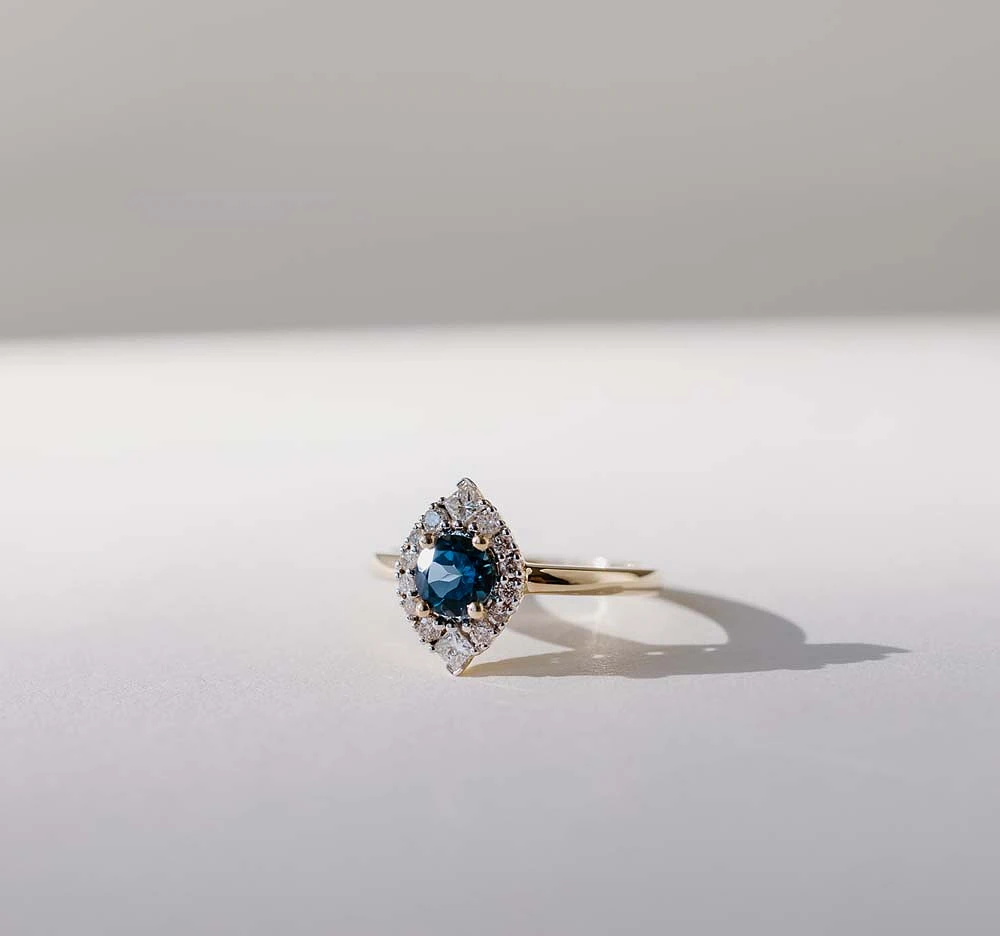 Halo Ring with 5MM Round London Blue Topaz and .25 Carat TW of Diamonds 14kt Yellow Gold