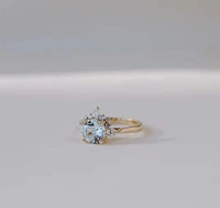 Ring with 7MM Round Aquamarine and .25 Carat TW of Diamonds 14kt Yellow Gold