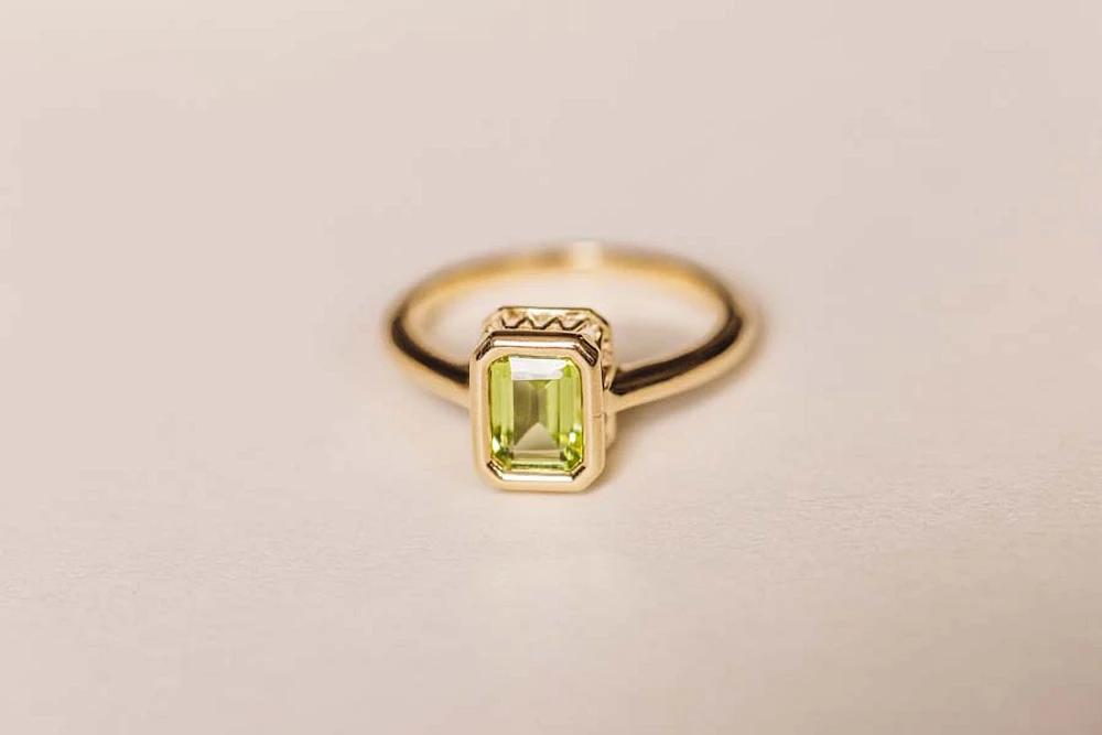 Ring with 7x5MM Emerald Cut Peridot 10kt Yellow Gold