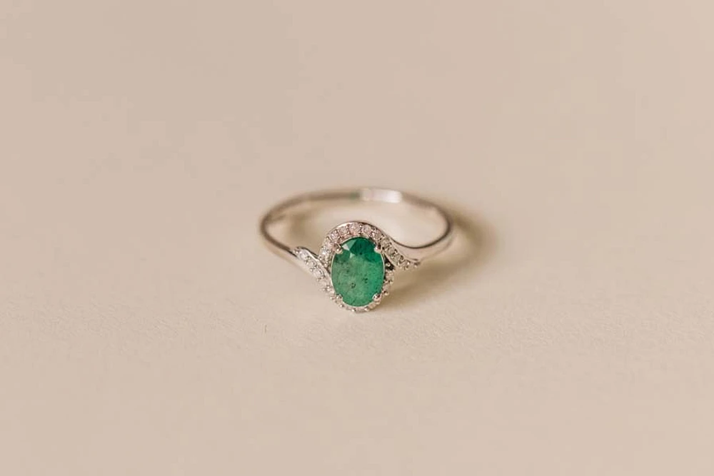 Halo Ring with .10 Carat TW of Diamonds and 7x5MM Oval Emerald 10kt White Gold