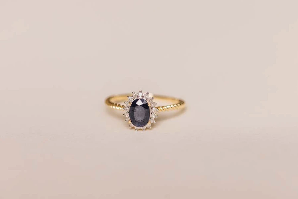 Halo Ring with .13 Carat TW of Diamonds and 7x5MM Oval Blue Sapphire 10kt Yellow Gold