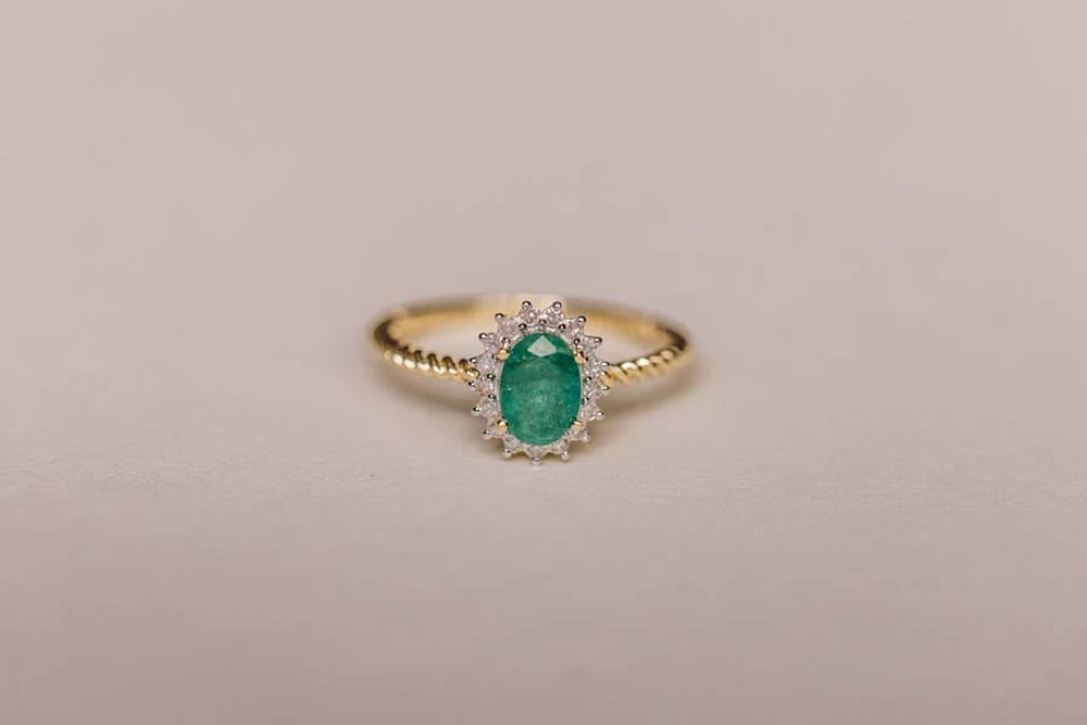 Halo Ring with .13 Carat TW of Diamonds and 7x5MM Oval Emerald 10kt Yellow Gold