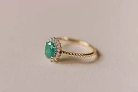 Halo Ring with .13 Carat TW of Diamonds and 7x5MM Oval Emerald 10kt Yellow Gold