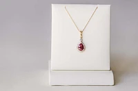 Halo Pendant with .13 Carat TW of Diamonds and 7x5MM Pear Shape Ruby 10kt Yellow Gold Chain