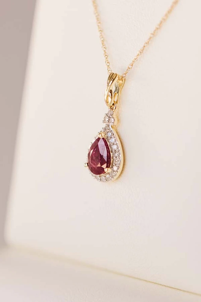 Halo Pendant with .13 Carat TW of Diamonds and 7x5MM Pear Shape Ruby 10kt Yellow Gold Chain