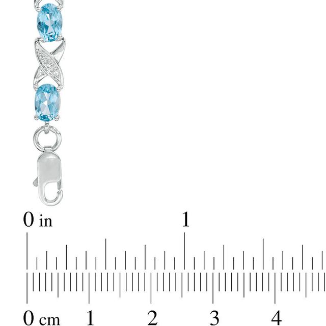 Sideways Oval Swiss Blue Topaz and Diamond Accent "XO" Bracelet in Sterling Silver - 7.25"|Peoples Jewellers