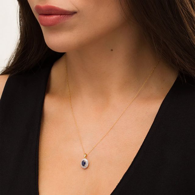 Oval Blue Sapphire and 0.19 CT. T.W. Baguette and Round Diamond Double Frame Floral Drop Pendant in 10K Gold