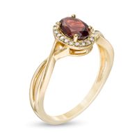 Oval Garnet and 0.08 CT. T.W. Diamond Frame Twist Shank Ring in 10K Gold|Peoples Jewellers