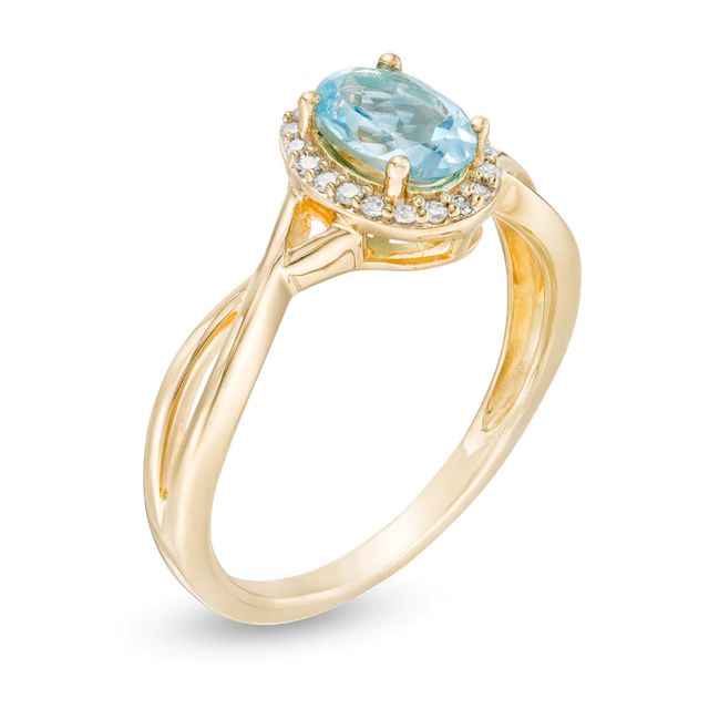 Oval Swiss Blue Topaz and 0.08 CT. T.W. Diamond Frame Twist Shank Ring in 10K Gold|Peoples Jewellers