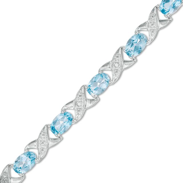 Previously Owned - Sideways Oval Swiss Blue Topaz and Diamond Accent "XO" Bracelet in Sterling Silver - 7.25"|Peoples Jewellers