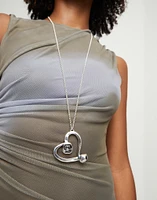 Long chain pendant necklace with a large heart