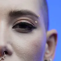 Golden Ball Eyebrow Piercing