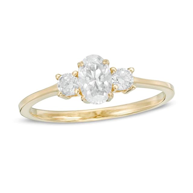 5/8 CT. T.w. Oval and Round Diamond Three Stone Engagement Ring in 14K Gold