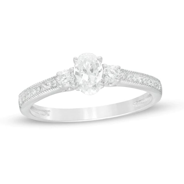 5/8 CT. T.w. Oval and Round Diamond Three Stone Engagement Ring in 14K White Gold