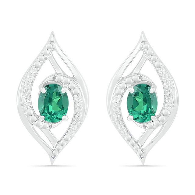 Lab-Created Oval Emerald and 1/15 CT. T.w. Diamond Bypass Flame Stud Earrings in Sterling Silver