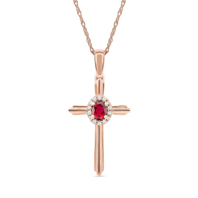 Oval Ruby and 1/20 CT. T.w. Diamond Frame Layered Cross Pendant in 10K Rose Gold