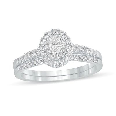 1/2 CT. T.w. Oval Diamond Frame Bridal Set in 10K White Gold