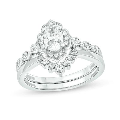 3/4 CT. T.w. Oval Diamond Frame Vintage-Style Bridal Set in 14K White Gold (I/I2)