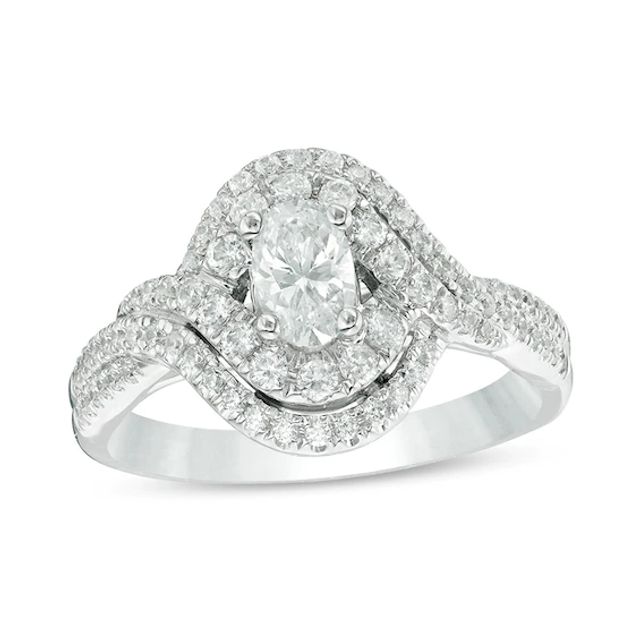 Previously Owned - Celebration Ideal 1 CT. T.w. Oval Diamond Bypass Frame Engagement Ring in 14K White Gold (I/I1)