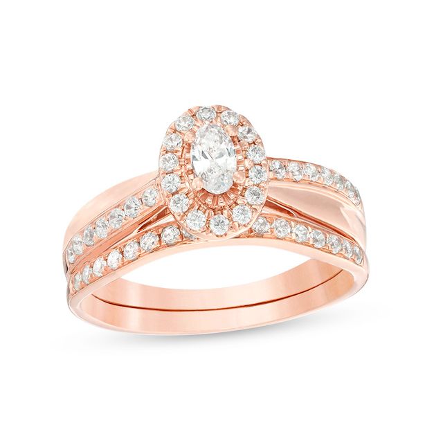 Previously Owned - 3/4 CT. T.w. Oval Diamond Frame Crossover Bridal Set in 14K Rose Gold