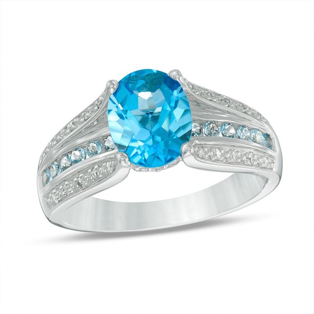 Previously Owned - Oval Swiss Blue Topaz and 1/10 CT. T.w. Diamond Triple Row Cathedral Ring in 10K White Gold