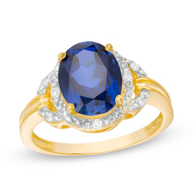 Previously Owned - Oval Lab-Created Blue Sapphire and 1/20 CT. T.w. Diamond Frame Buckle Ring in 10K Gold