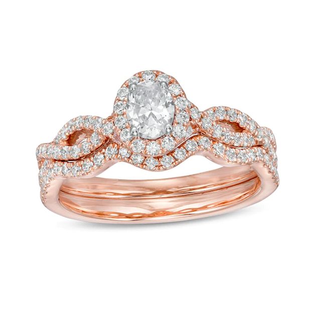 Previously Owned - 1 CT. T.w. Oval Diamond Frame Split Shank Bridal Set in 14K Rose Gold