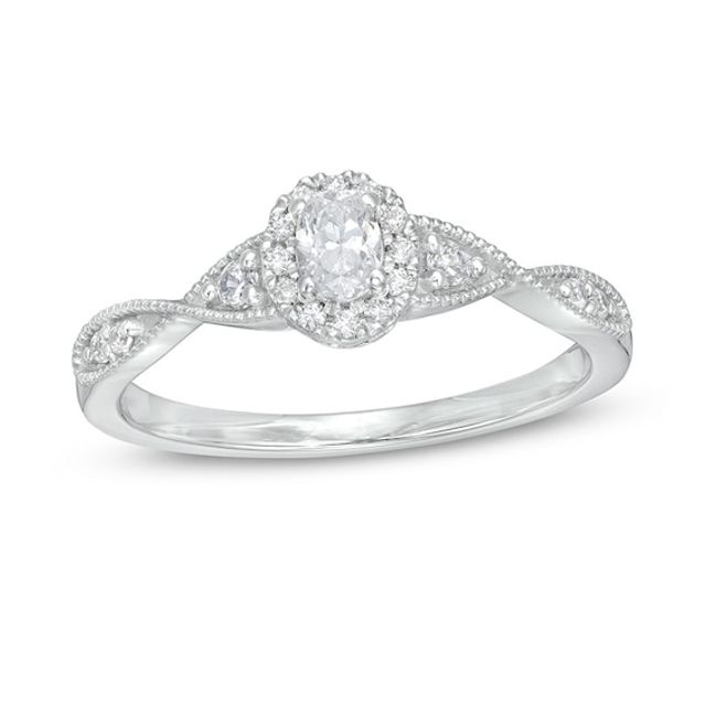 Previously Owned - 1/3 CT. T.w. Oval Diamond Frame Twist Shank Engagement Ring in 14K White Gold (I/Si2)